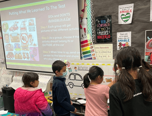 Elementary kids learning about safe passenger behavior during an educational workshop